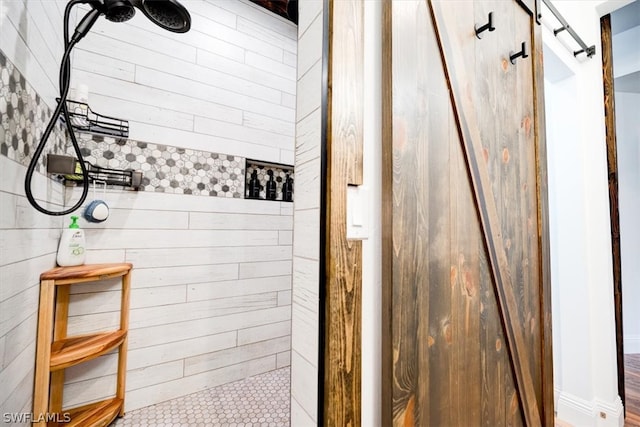 bathroom featuring wooden walls and a tile shower