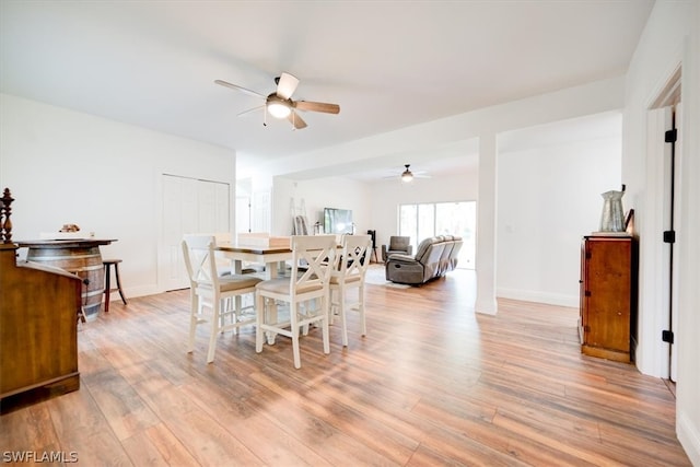 dining area featuring light hardwood / wood-style floors and ceiling fan