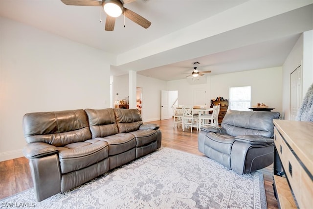 living room with ceiling fan and light wood-type flooring