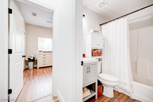 full bathroom with shower / tub combo, toilet, vanity, and hardwood / wood-style flooring