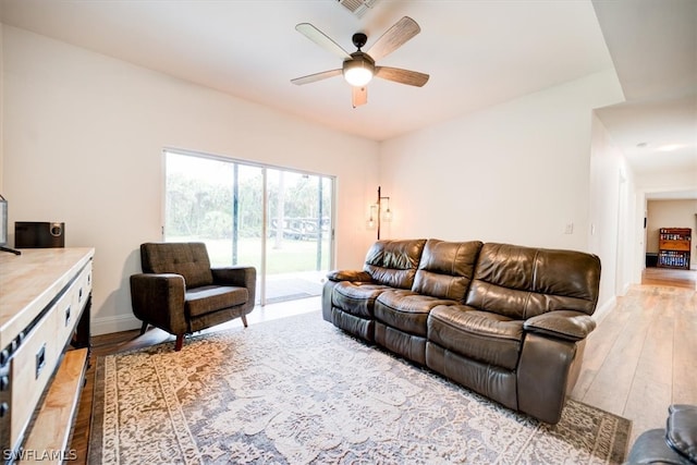 living room featuring light hardwood / wood-style flooring and ceiling fan