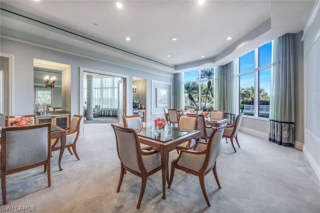 dining space with baseboards, light colored carpet, a tray ceiling, a chandelier, and recessed lighting