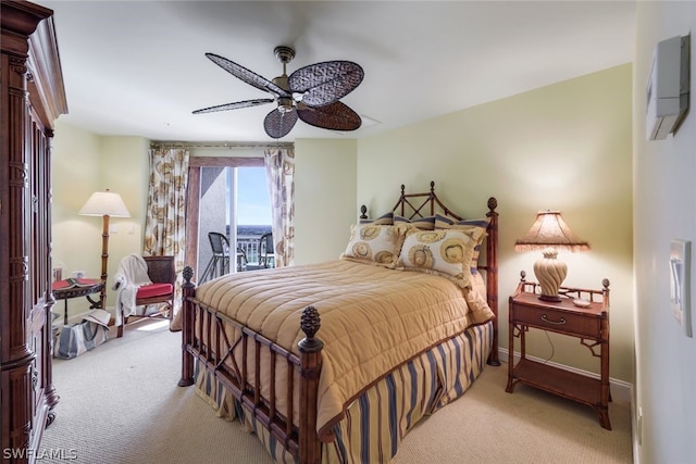 bedroom featuring light carpet, baseboards, a ceiling fan, a wall unit AC, and access to exterior