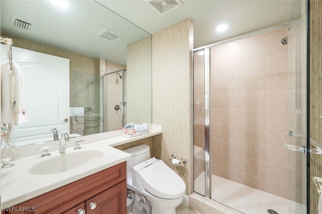 bathroom featuring toilet, vanity, and an enclosed shower