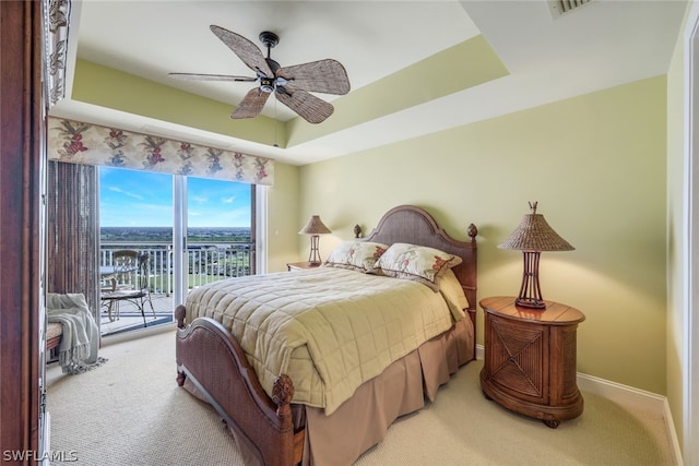 bedroom featuring a raised ceiling, access to outside, carpet floors, and ceiling fan