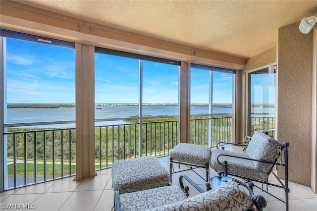 sunroom featuring a water view and a healthy amount of sunlight