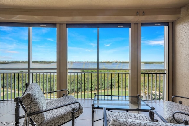 sunroom / solarium with a water view