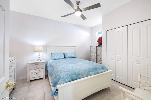 bedroom with a closet, ceiling fan, and light tile patterned flooring