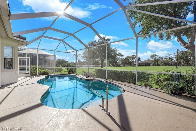 view of pool with a patio and a lanai