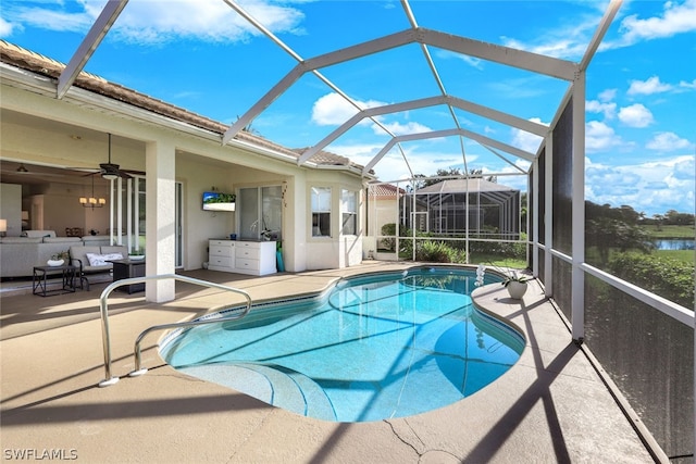 view of swimming pool featuring glass enclosure and a patio area