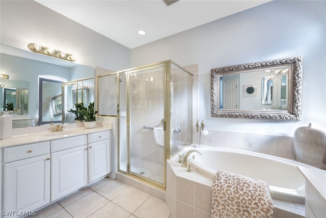 bathroom featuring tile patterned floors, vanity, and plus walk in shower