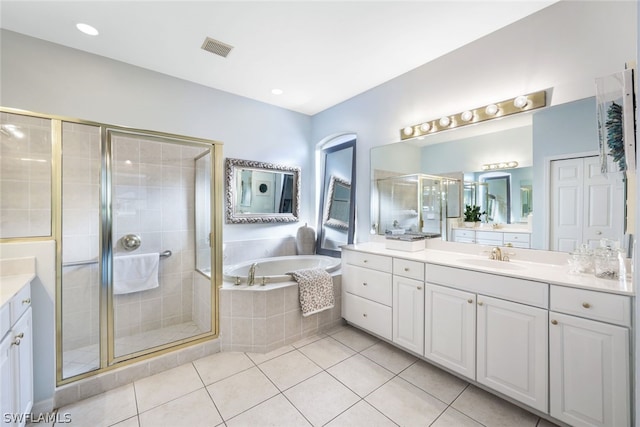 bathroom featuring tile patterned floors, vanity, and separate shower and tub