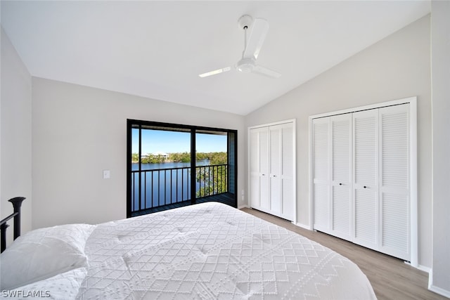 bedroom with lofted ceiling, access to exterior, ceiling fan, multiple closets, and wood-type flooring