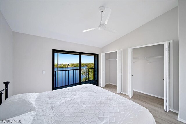 bedroom with access to outside, light wood-type flooring, lofted ceiling, two closets, and ceiling fan