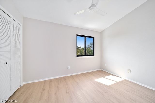 unfurnished bedroom with ceiling fan, light hardwood / wood-style flooring, and a closet