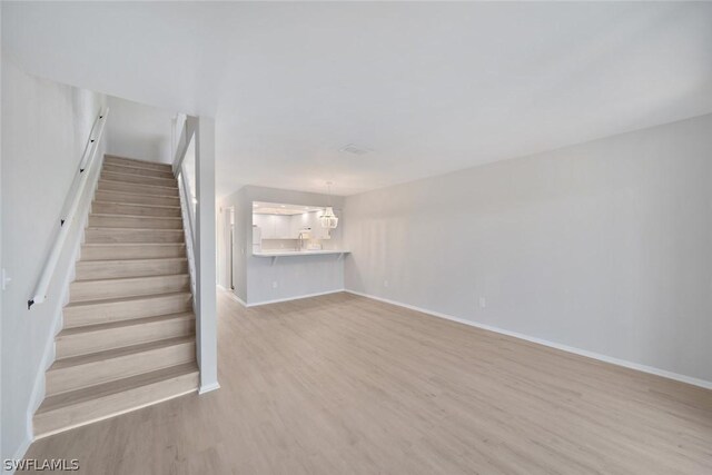 unfurnished living room featuring light wood-type flooring