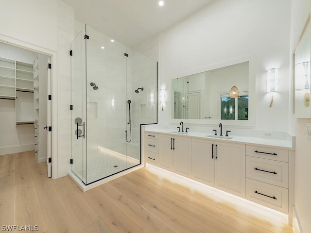 bathroom featuring vanity, a shower with door, and hardwood / wood-style floors