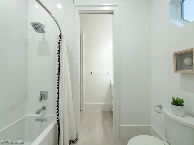 full bathroom with vanity, tiled shower / bath combo, and toilet