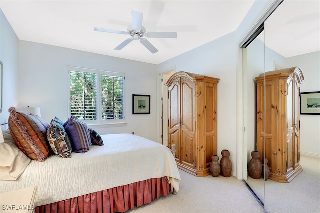 bedroom with carpet, ceiling fan, and a closet