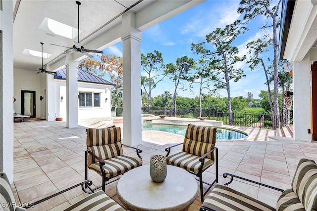 view of patio / terrace featuring ceiling fan and a fenced in pool