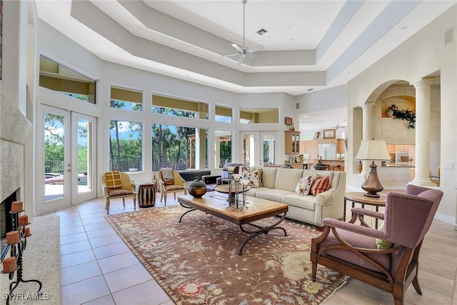 27820 Riverwalk Way, Bonita Springs, FL 34134 - living area featuring ceiling fan, a high ceiling, light tile patterned floors, ornate columns, and french doors