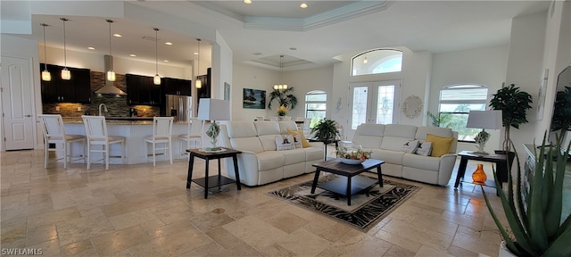 living room featuring french doors, light tile floors, and a high ceiling