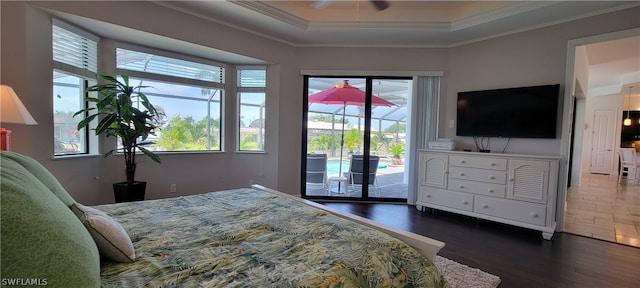 bedroom featuring a raised ceiling, access to exterior, ceiling fan, and dark wood-type flooring