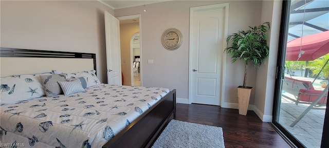 bedroom featuring access to exterior and dark wood-type flooring