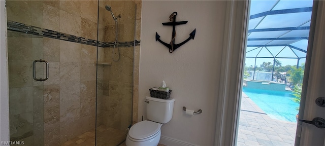 bathroom featuring toilet and a shower with door