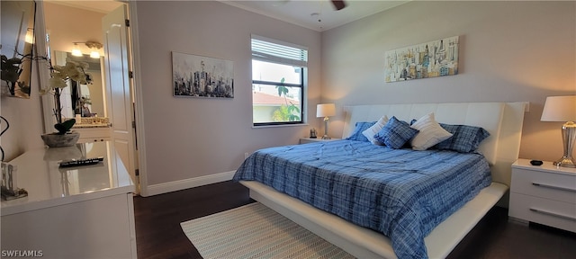 bedroom with dark hardwood / wood-style floors, ceiling fan, and ensuite bathroom