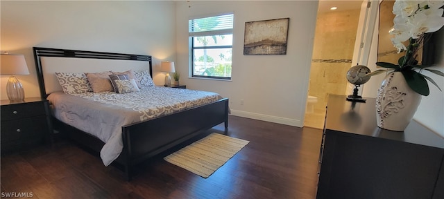 bedroom featuring connected bathroom and dark wood-type flooring