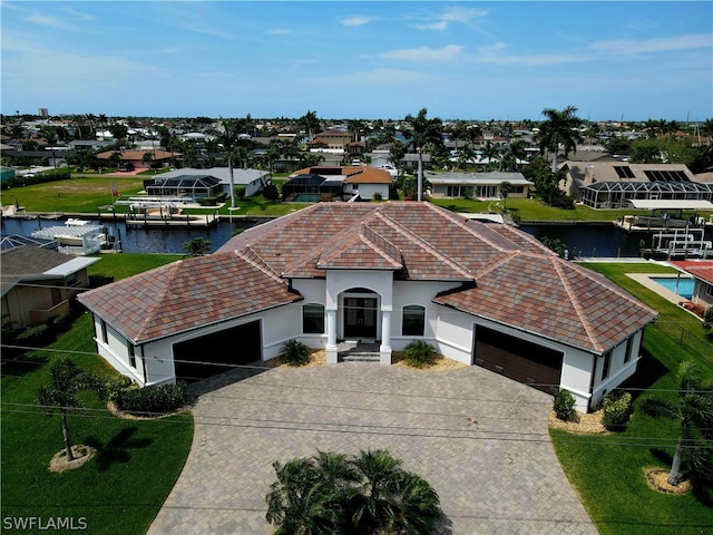 ranch-style house with a water view, a front yard, and a boat dock