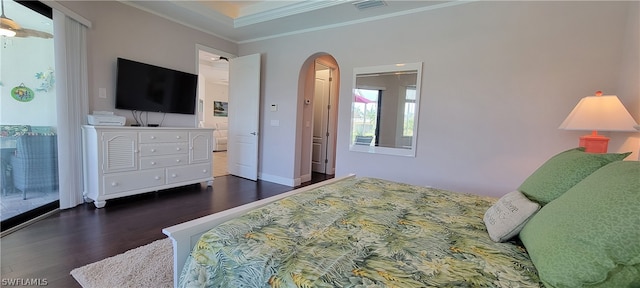 bedroom with crown molding and dark wood-type flooring