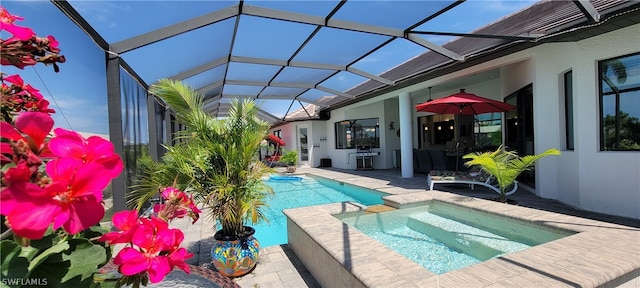 view of swimming pool featuring a patio area, an in ground hot tub, and a lanai