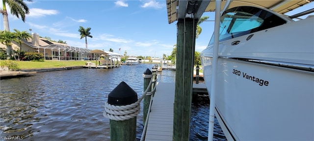 view of dock featuring glass enclosure and a water view