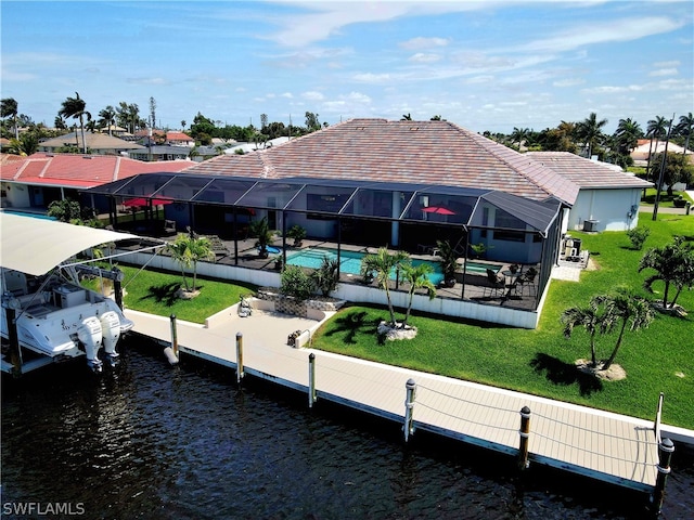 dock area with glass enclosure, a water view, a yard, and a patio