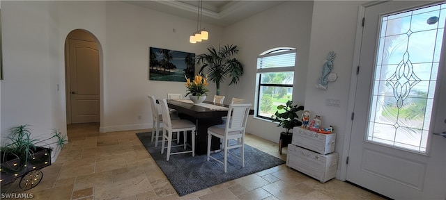 dining area featuring crown molding and light tile floors