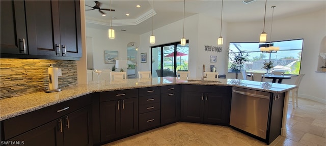 kitchen with pendant lighting, stainless steel dishwasher, light stone counters, and sink