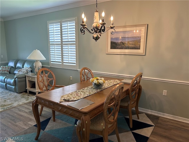 dining space with an inviting chandelier, crown molding, and dark hardwood / wood-style flooring