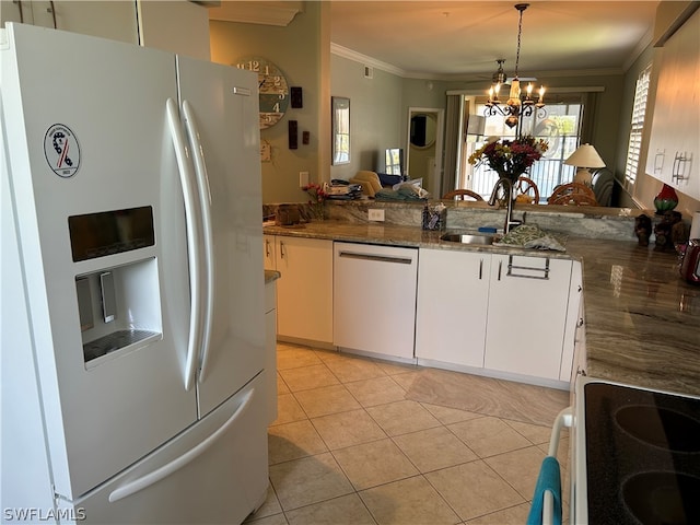 kitchen with a chandelier, white appliances, white cabinetry, and sink