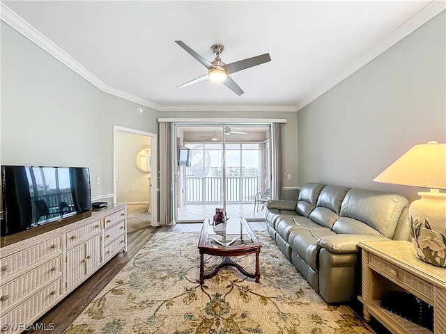 living room featuring ceiling fan, dark wood-type flooring, and ornamental molding