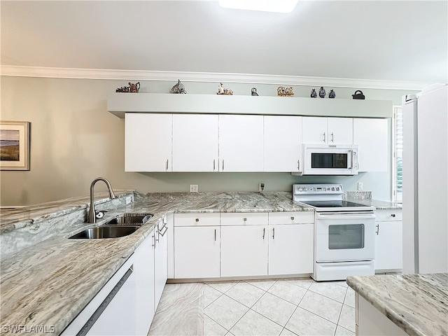 kitchen featuring white appliances, white cabinetry, and sink