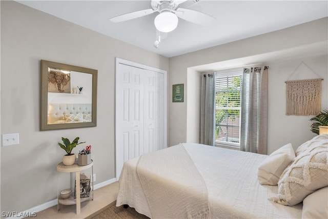 bedroom featuring baseboards, a closet, carpet flooring, and a ceiling fan