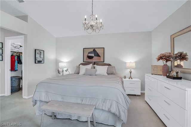 bedroom featuring vaulted ceiling, light carpet, baseboards, and a spacious closet