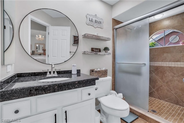 full bathroom with vanity, toilet, a notable chandelier, and a shower stall