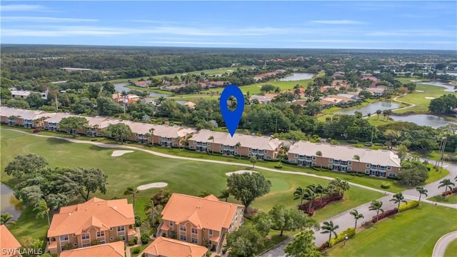 drone / aerial view featuring a residential view, a water view, and golf course view