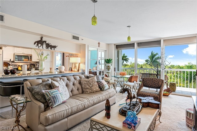 living room featuring floor to ceiling windows and visible vents