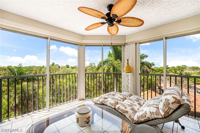 sunroom / solarium featuring ceiling fan and a wealth of natural light