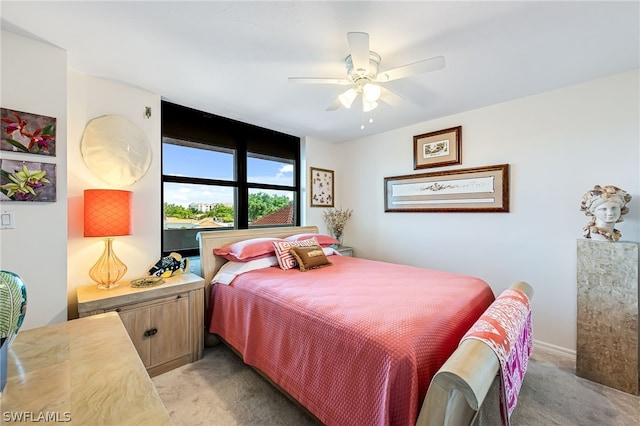 bedroom featuring light carpet and ceiling fan