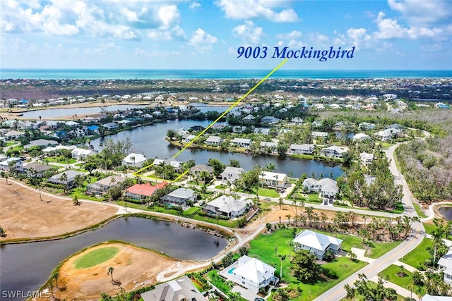 birds eye view of property with a residential view and a water view